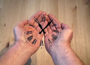 Hands Holding Time Clock